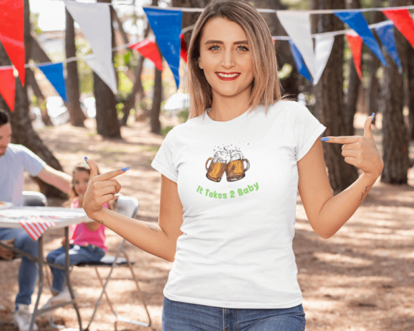 A woman wearing "It Takes 2 Baby" on a t-shirt